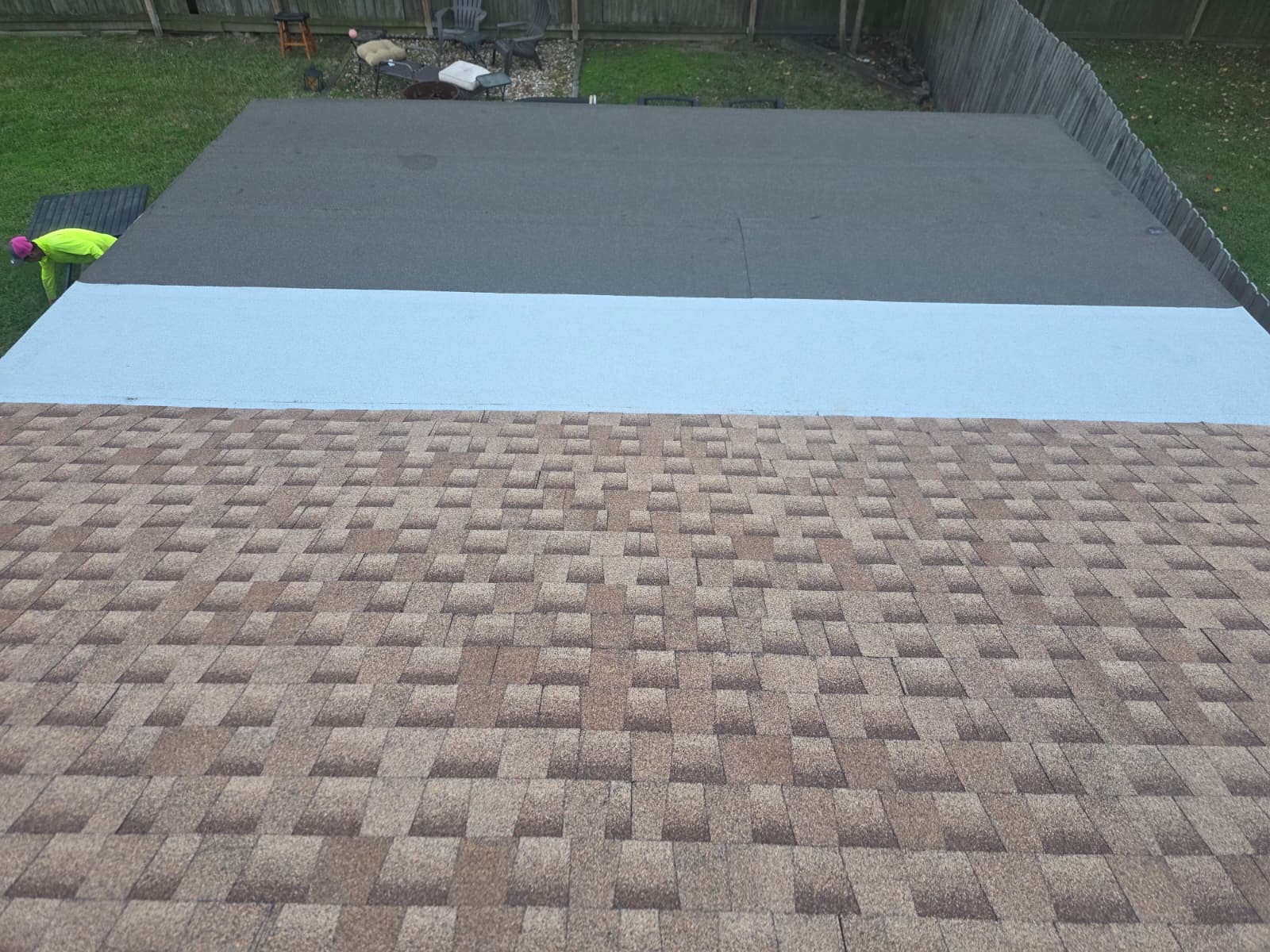 New architectural shingles and a fresh flat-roof membrane after replacement