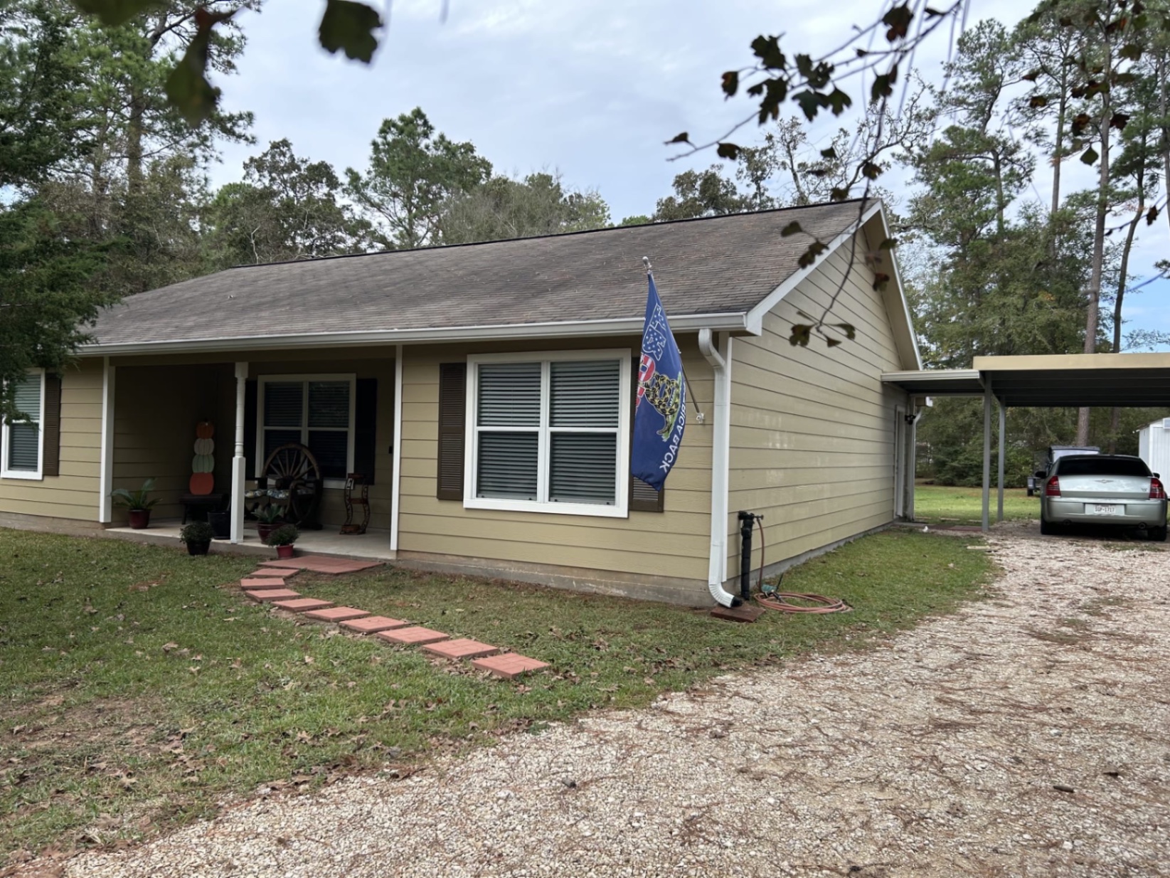 Weathered shingles with dark staining and surface wear before replacement